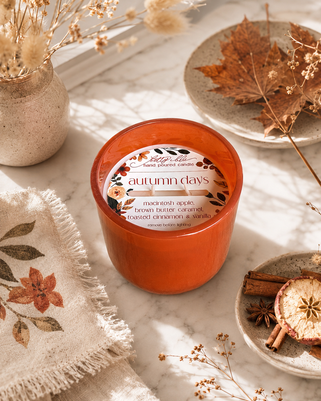 The Autumn Gift Set by Betty Blu, orange tin candle beside a wax melt tin