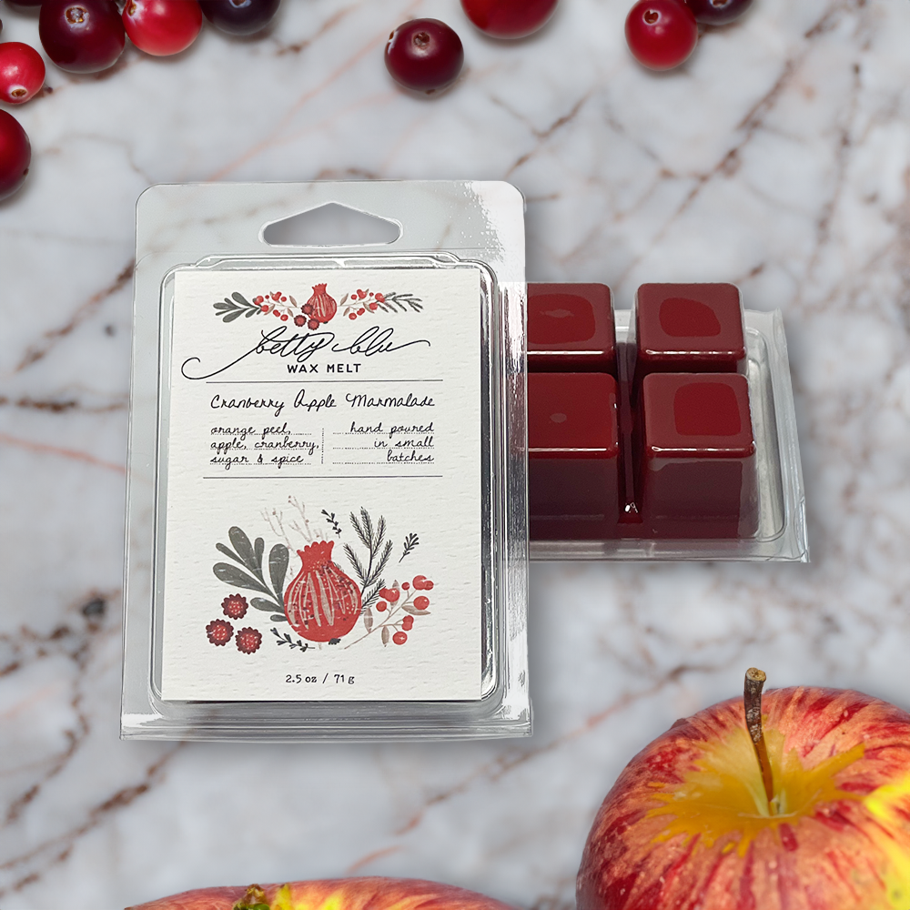 Wax melt packaging with cranberry and apple inspired design.