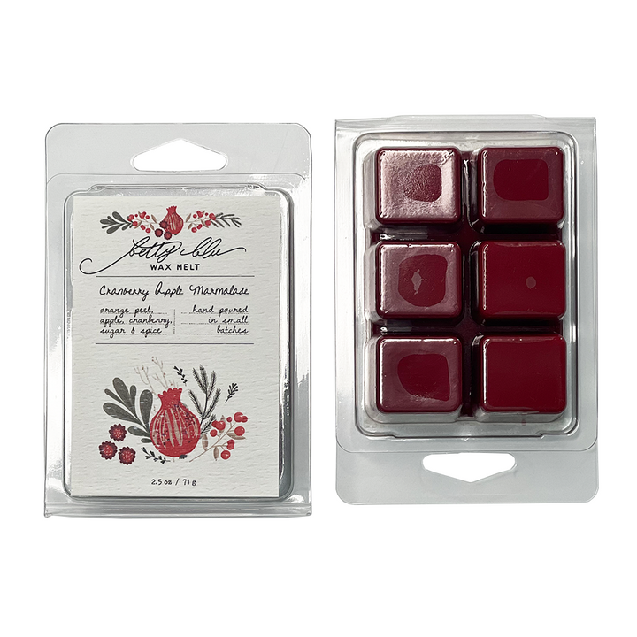 Cranberry wax melt cubes displayed with holiday fruit themed label.