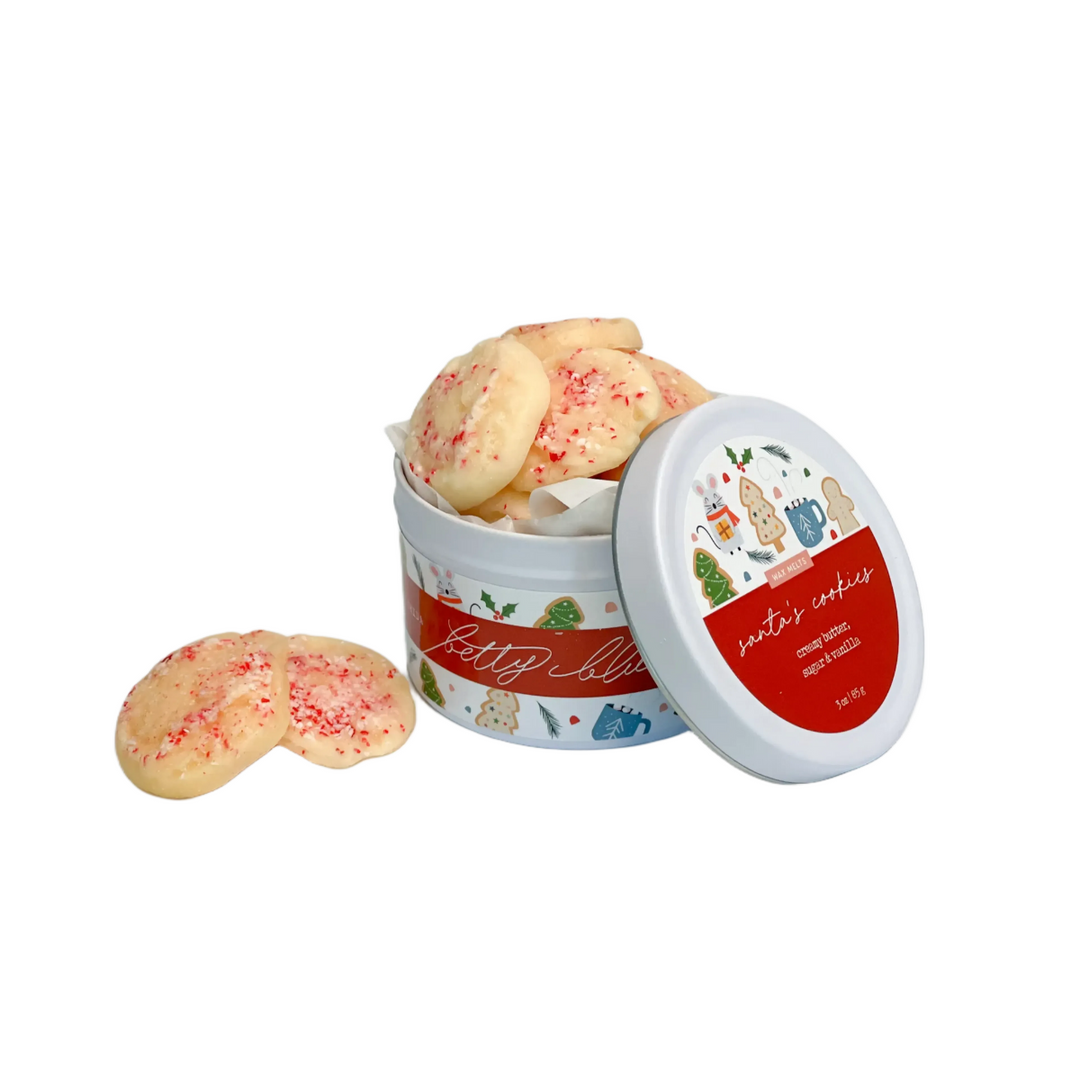 Sugar cookie-shaped wax melts with crushed red sprinkles in a festive illustrated tin — sweet Christmas scent of butter, vanilla, and cookie dough by Betty Blu