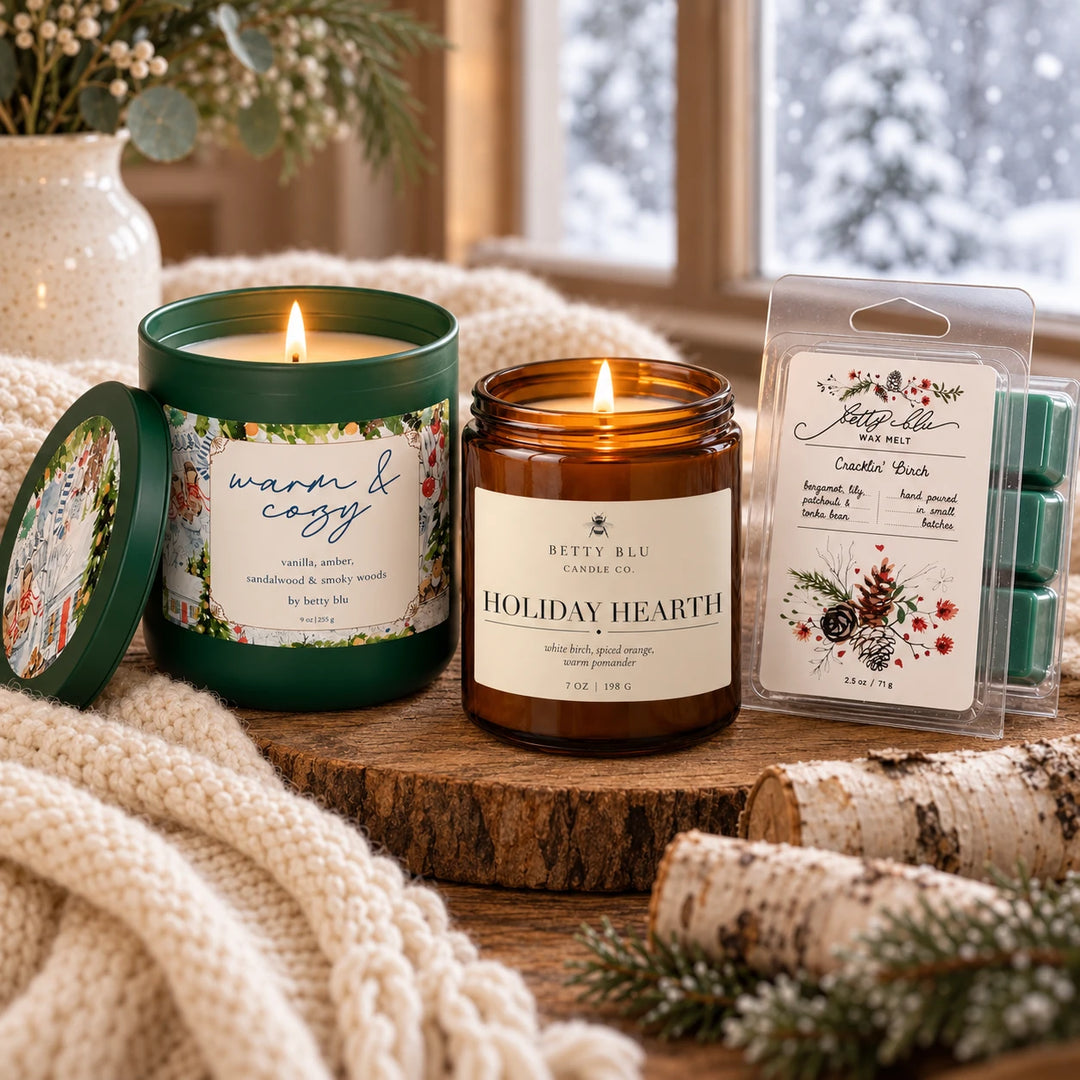 Fireside gift set by Betty Blu, Warm and Cozy and Holiday Hearth candles lit beside Cracklin Birch wax melts