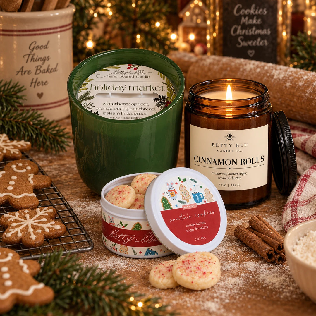 The Holiday Kitchen gift set by Betty Blu, Holiday Market and Cinnamon Rolls candles with a tin of Santa's Cookies wax melts