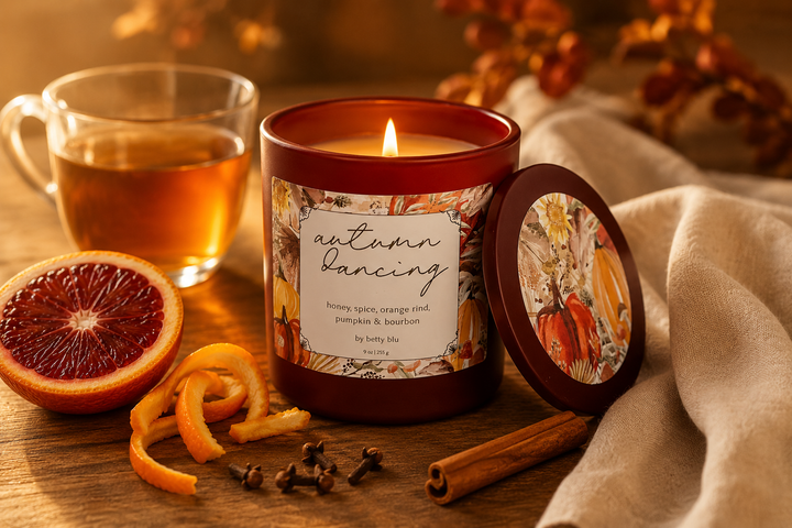 The Autumn Gift Set by Betty Blu, lit candle with fall leaves and fabric